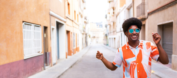 person with sunglasses walking on an empty street